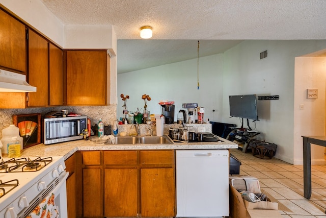 kitchen featuring white appliances, light tile floors, sink, a textured ceiling, and lofted ceiling