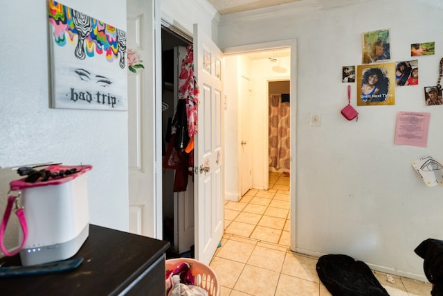 interior space with crown molding and light tile floors