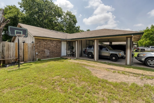 ranch-style house featuring a carport and a front yard