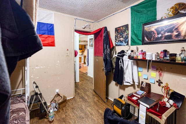 miscellaneous room featuring a textured ceiling and hardwood / wood-style flooring