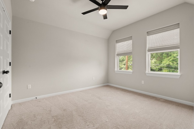 unfurnished room with ceiling fan, vaulted ceiling, and light colored carpet