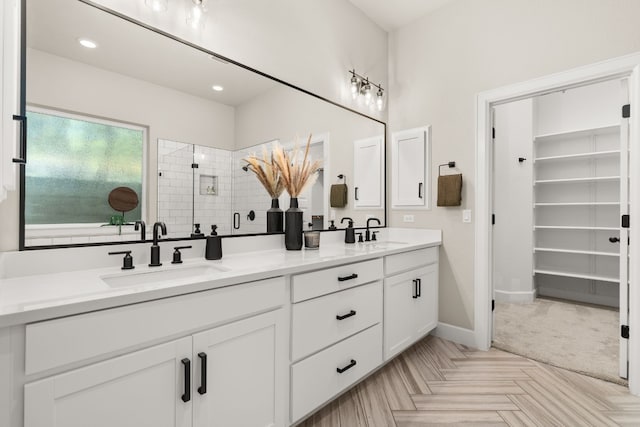 bathroom with dual vanity and parquet flooring