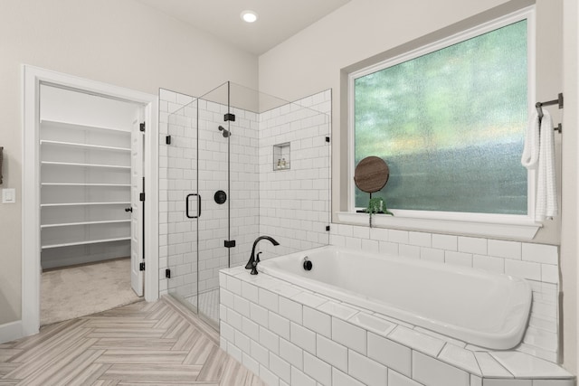 bathroom featuring parquet floors and plus walk in shower