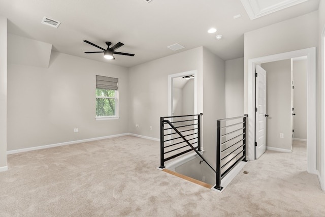 interior space with ceiling fan and light colored carpet