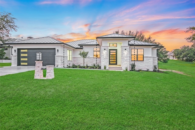 view of front facade with a garage and a yard