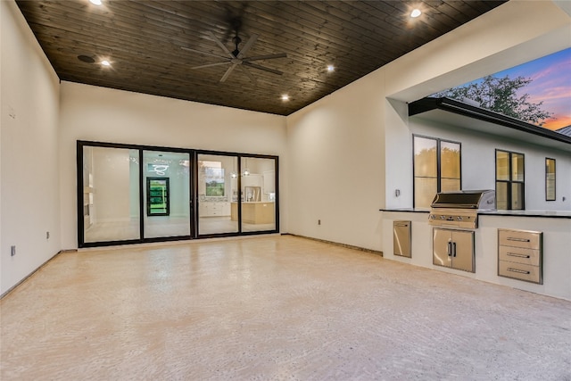 unfurnished living room with a high ceiling and ceiling fan