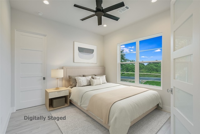 bedroom featuring ceiling fan and light hardwood / wood-style flooring