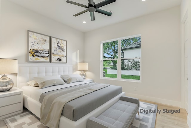 bedroom with ceiling fan and light hardwood / wood-style floors