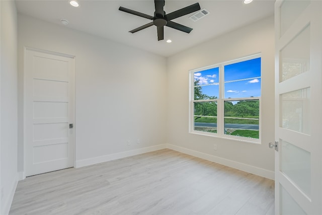 empty room featuring ceiling fan and light hardwood / wood-style flooring