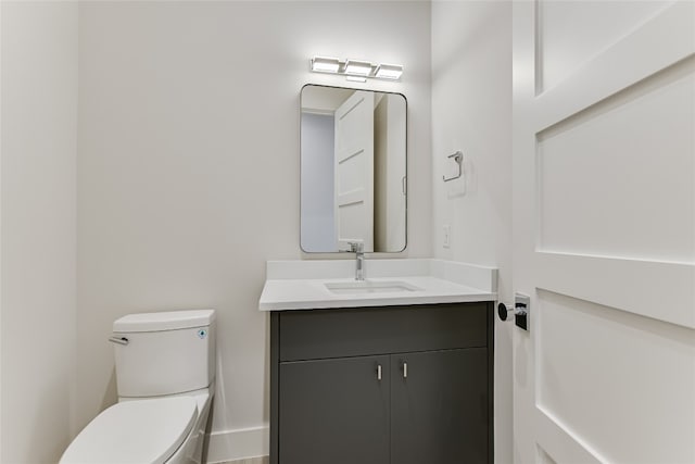 bathroom with toilet and large vanity