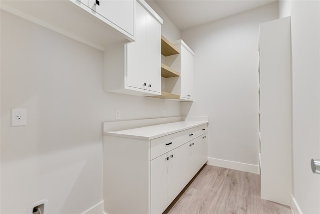 kitchen featuring light hardwood / wood-style floors and white cabinetry