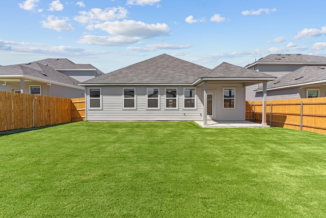 rear view of property with a patio area and a lawn