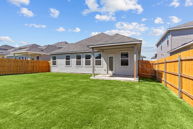 rear view of property with a patio and a yard