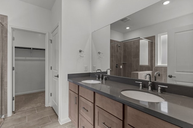 bathroom with vanity, hardwood / wood-style floors, and walk in shower