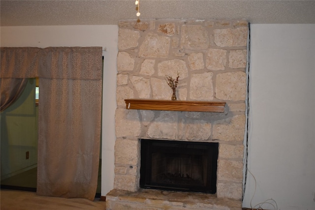 details with a fireplace and a textured ceiling