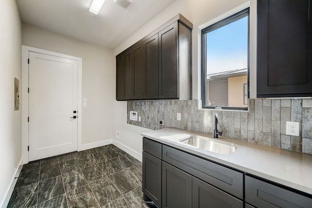 kitchen featuring sink, dark brown cabinets, and tasteful backsplash