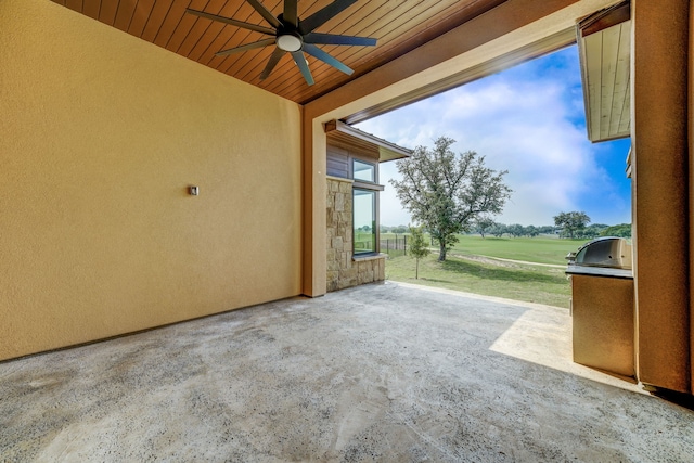 view of patio with ceiling fan, an outdoor kitchen, and a grill