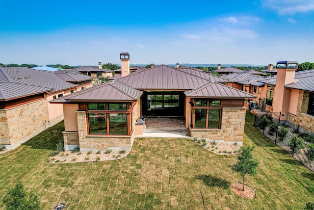 rear view of property with a lawn