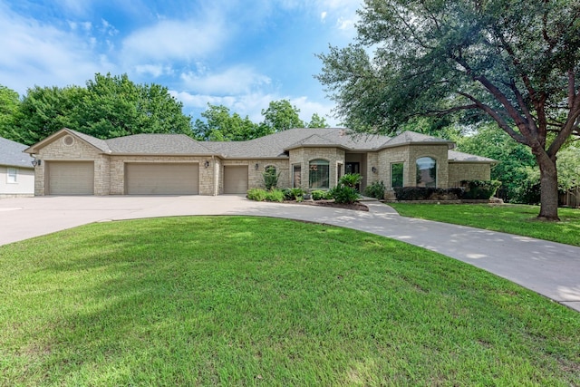 view of front of house with a front lawn and a garage