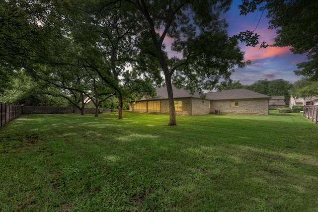 view of yard at dusk