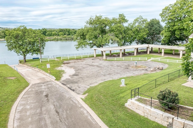 surrounding community featuring a water view and a yard