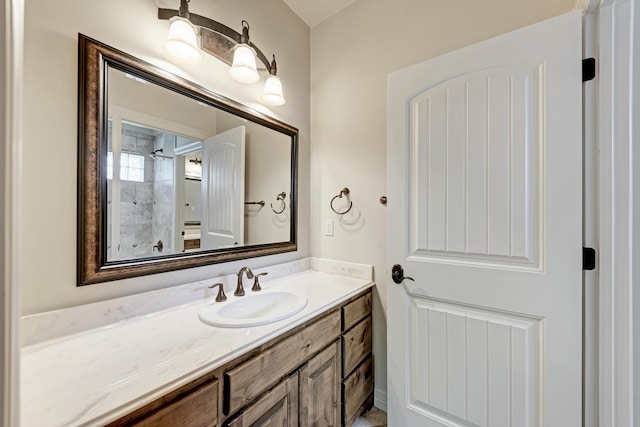 bathroom with walk in shower and vanity