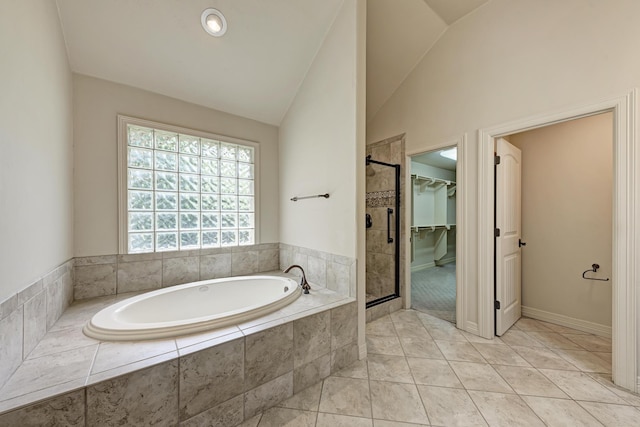 bathroom with plus walk in shower, tile patterned flooring, and lofted ceiling