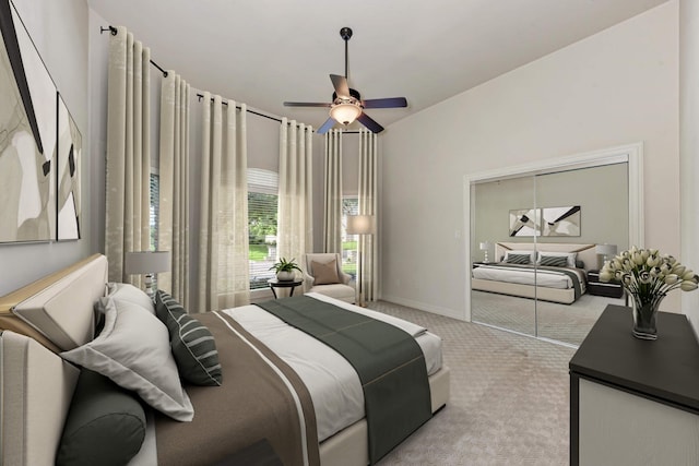 carpeted bedroom featuring ceiling fan and a closet