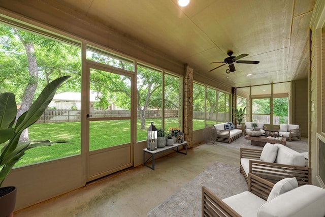 sunroom / solarium featuring ceiling fan