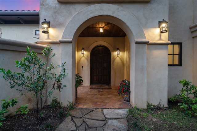 view of exterior entry at dusk