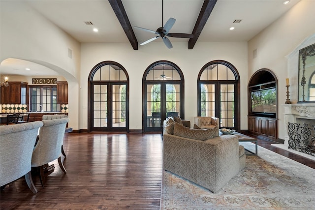 living room with french doors, dark wood-type flooring, beam ceiling, and ceiling fan