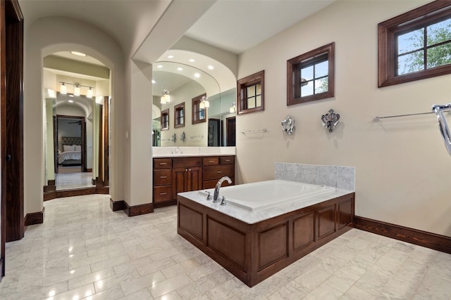 bathroom featuring vanity, a tub, and tile floors