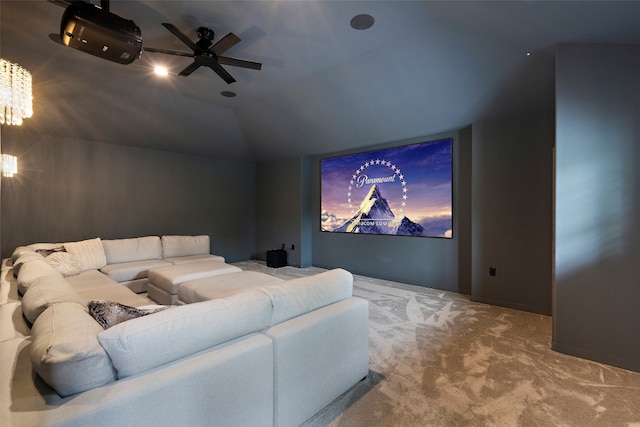 carpeted home theater room with lofted ceiling and ceiling fan