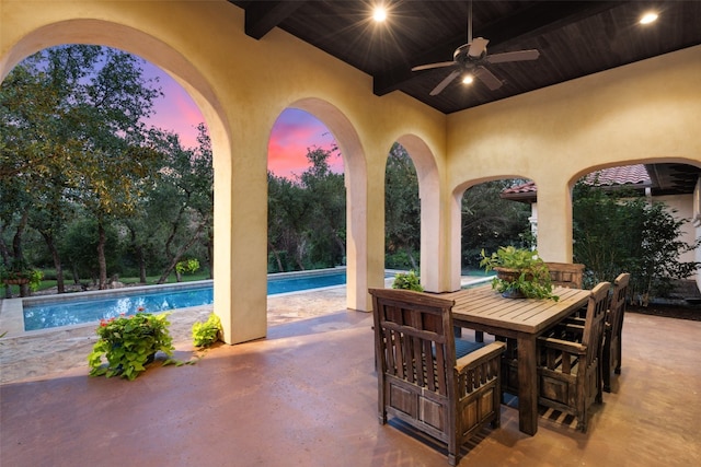 patio terrace at dusk featuring ceiling fan