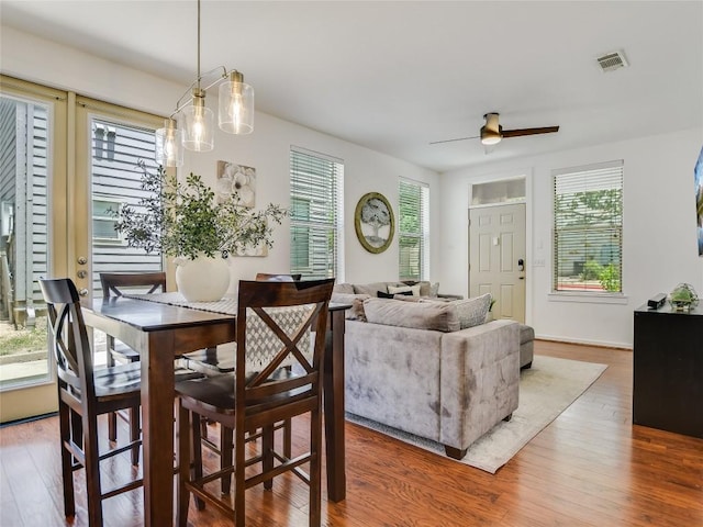 dining space featuring ceiling fan and wood-type flooring