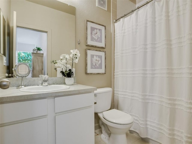 bathroom with tile patterned floors, vanity, and toilet