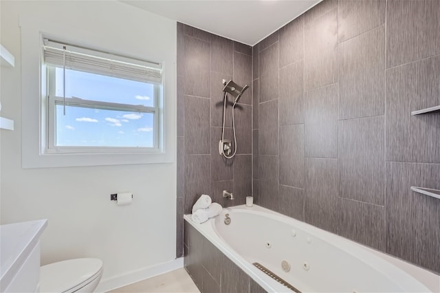 bathroom with tiled shower / bath combo and toilet