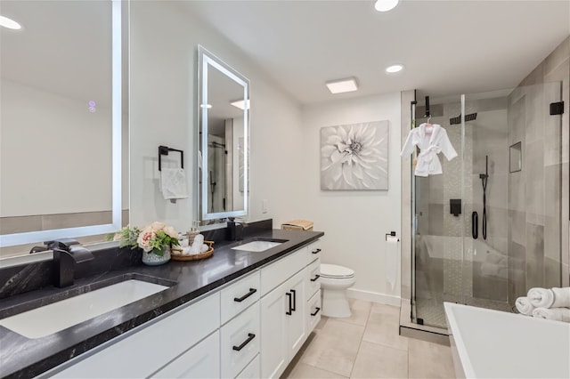 bathroom featuring tile patterned flooring, vanity, toilet, and a shower with door