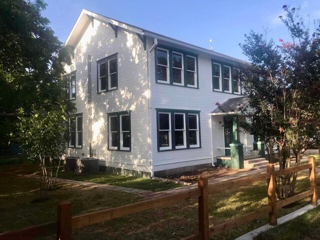 view of side of home with central AC