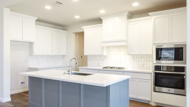 kitchen featuring white cabinets, an island with sink, and appliances with stainless steel finishes