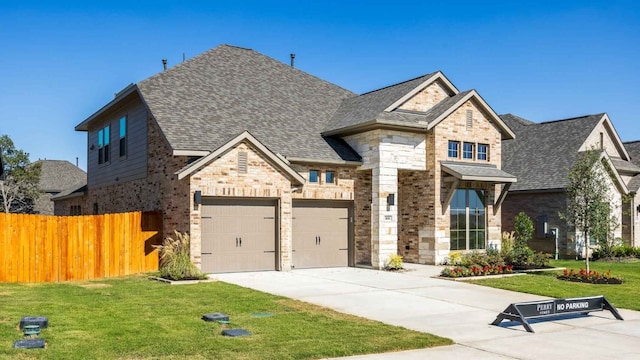 view of front of property with a front lawn and a garage