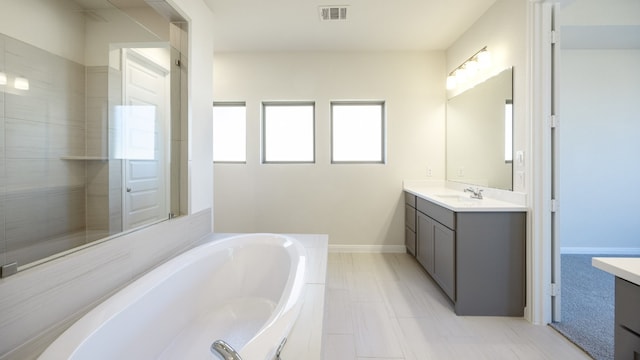 bathroom featuring a bath and vanity