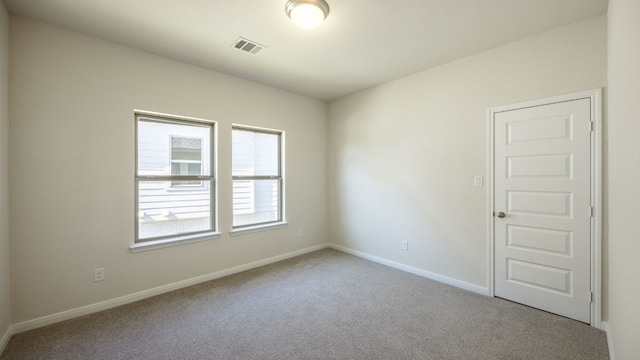 unfurnished room featuring light colored carpet