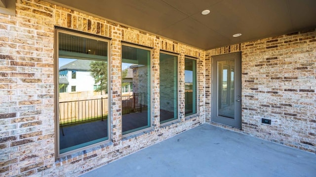 property entrance featuring a patio area