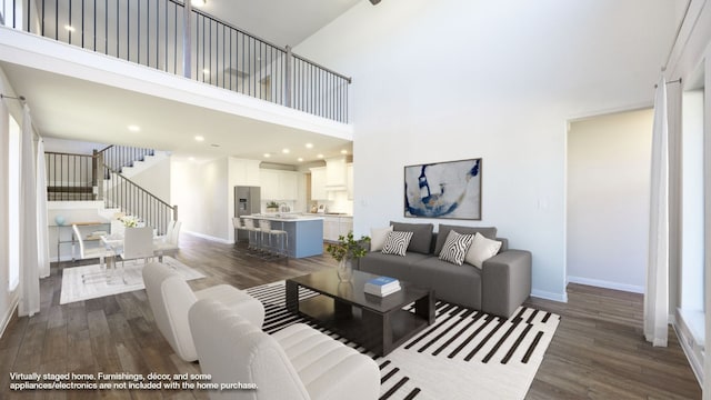 living room featuring a high ceiling and dark hardwood / wood-style floors