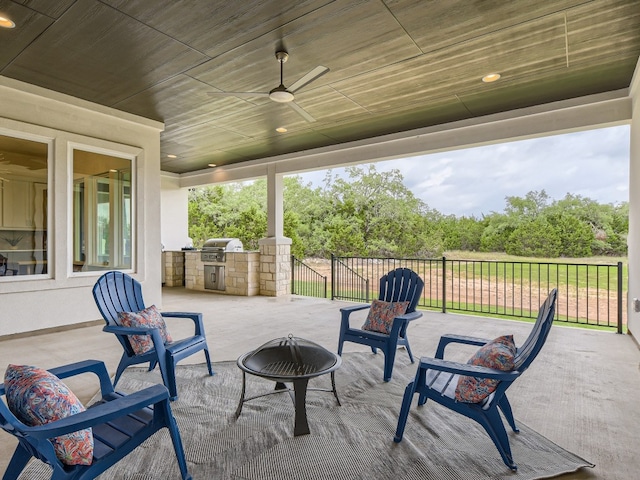 view of patio / terrace with ceiling fan, exterior kitchen, and area for grilling