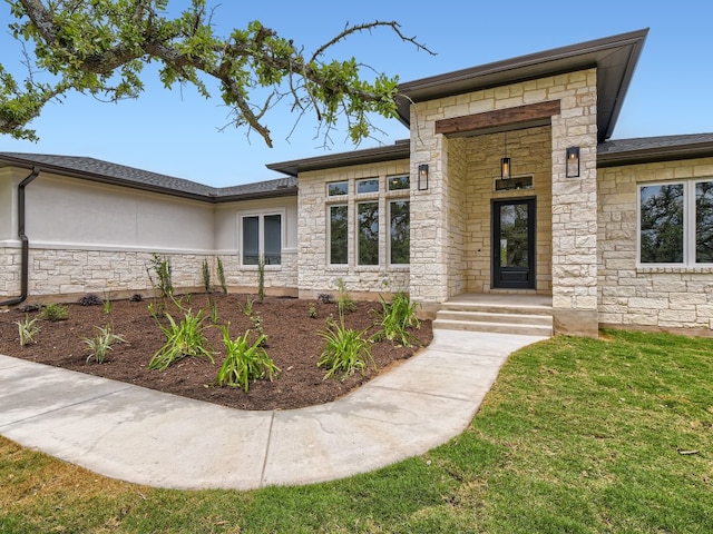 prairie-style house with stone siding and stucco siding