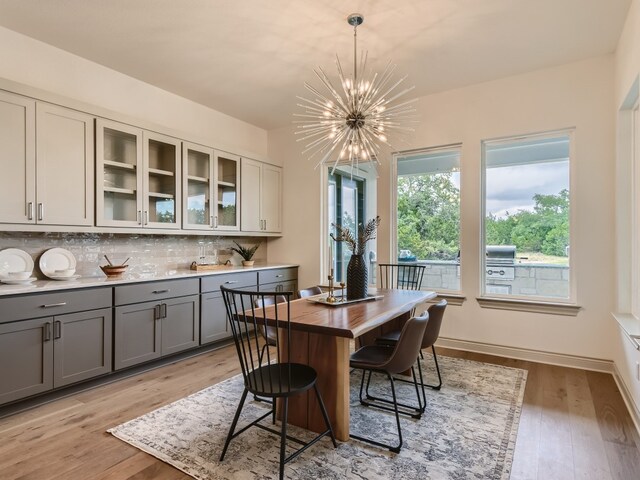 dining room with light wood-type flooring and a chandelier