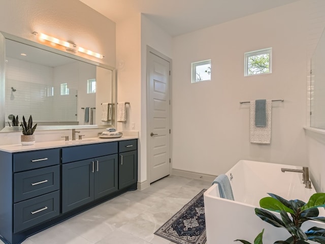 bathroom featuring vanity, a bathing tub, and tile patterned flooring