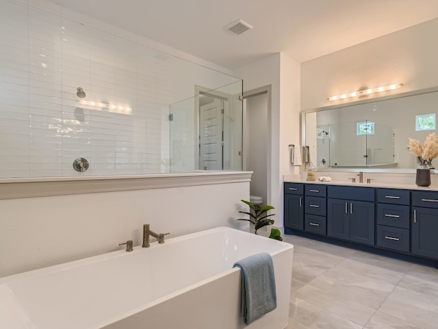 bathroom featuring tile patterned floors, shower with separate bathtub, and double vanity